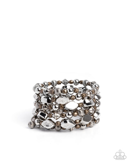 Stack of silver and bronze beaded bracelets on a white background