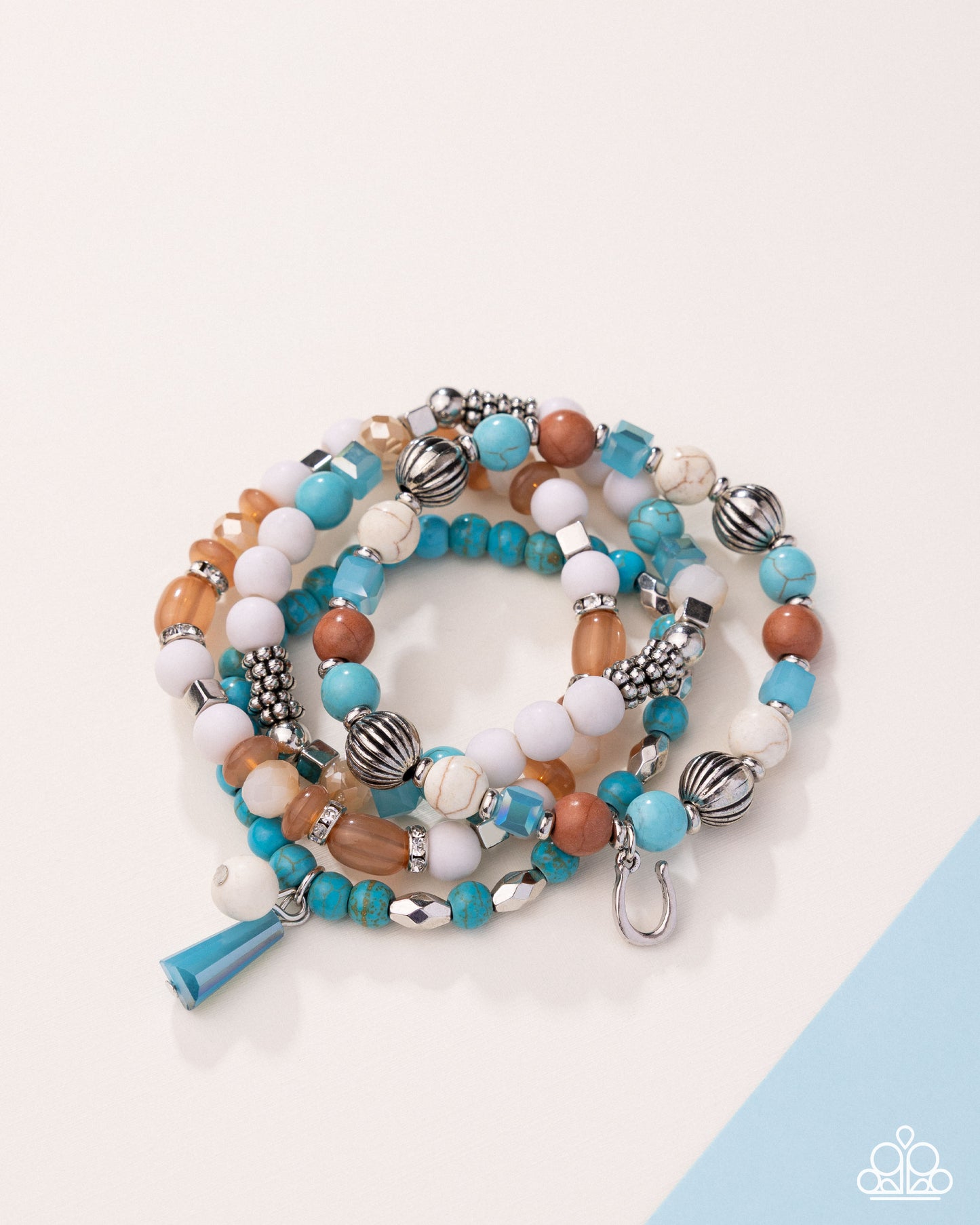 Stack of colorful beaded bracelets on a light background