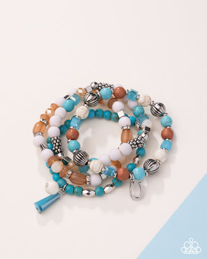 Stack of colorful beaded bracelets on a light background