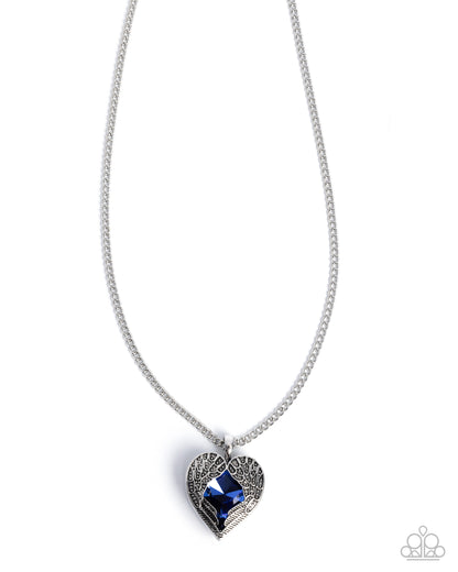Heart-shaped pendant with blue gemstone on a silver chain against a white background