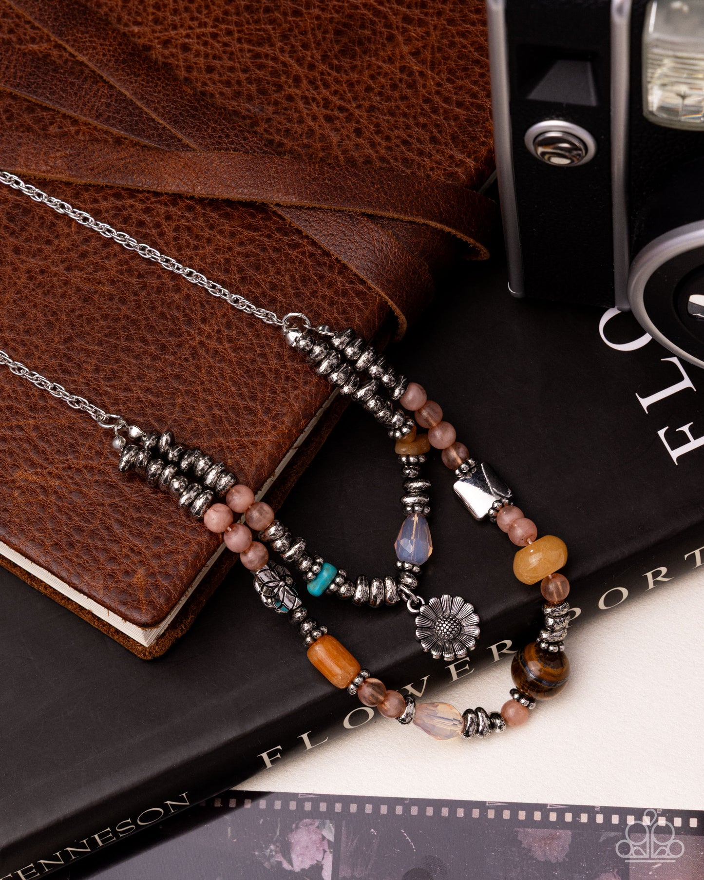 Necklace with beads on a book with a brown leather cover