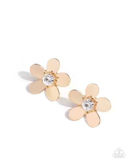 Pair of gold flower-shaped earrings with clear gemstones on a white background