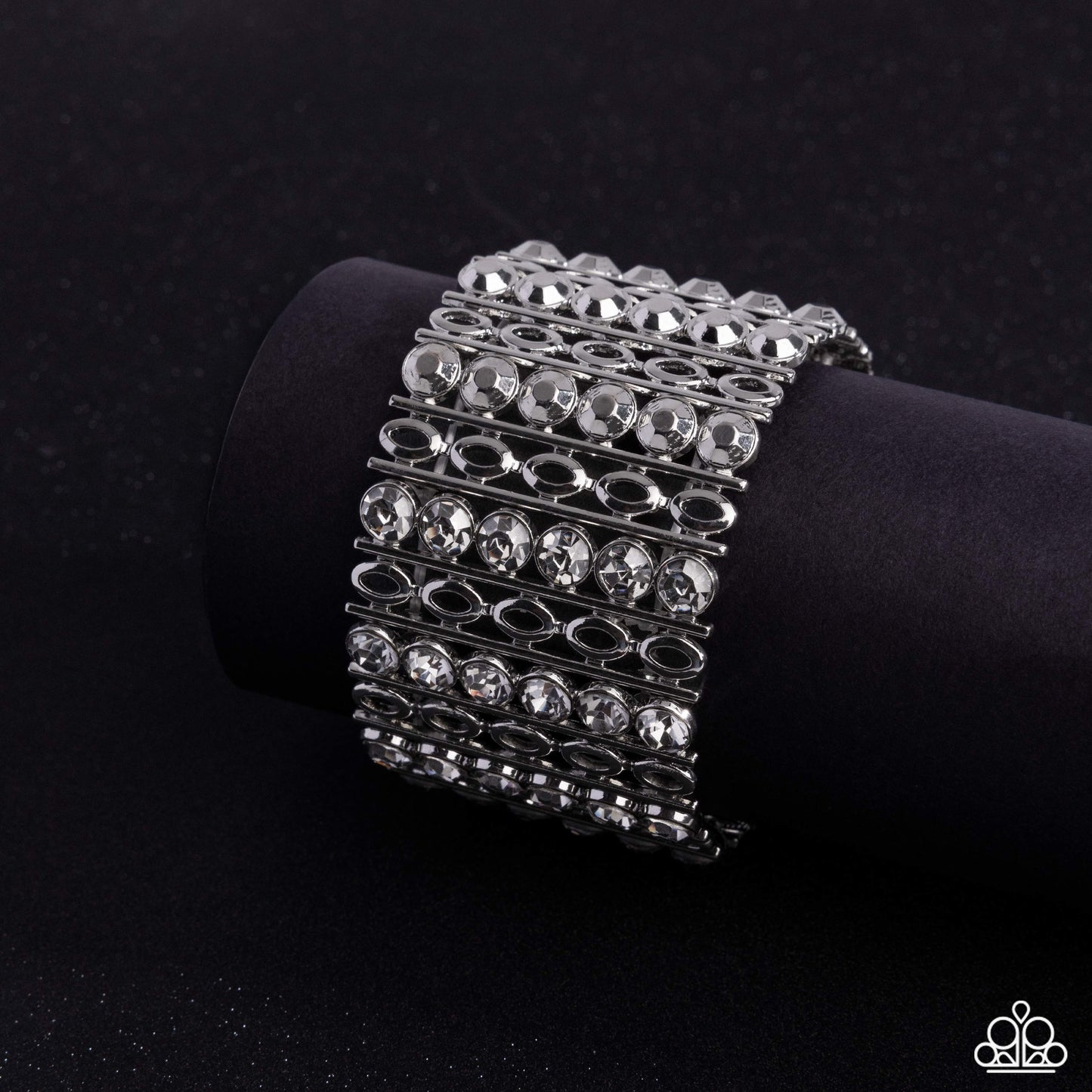Silver bracelet with clear stones on a black background