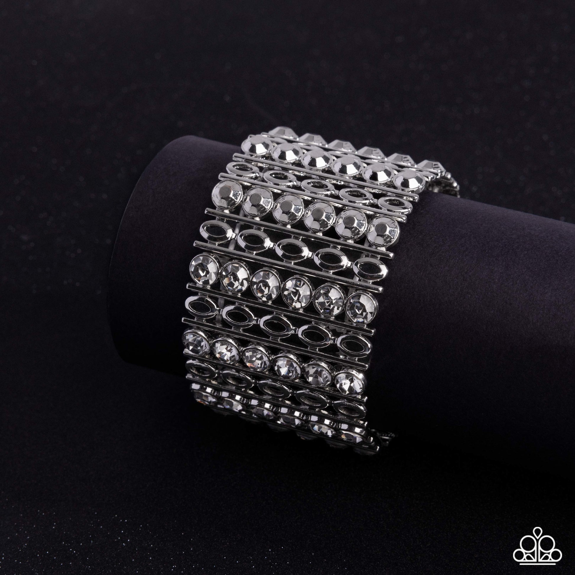 Silver bracelet with clear stones on a black background