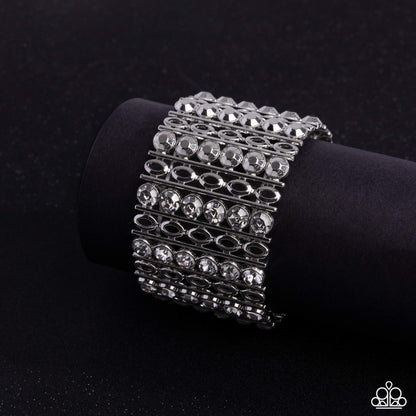 Silver bracelet with clear stones on a black background
