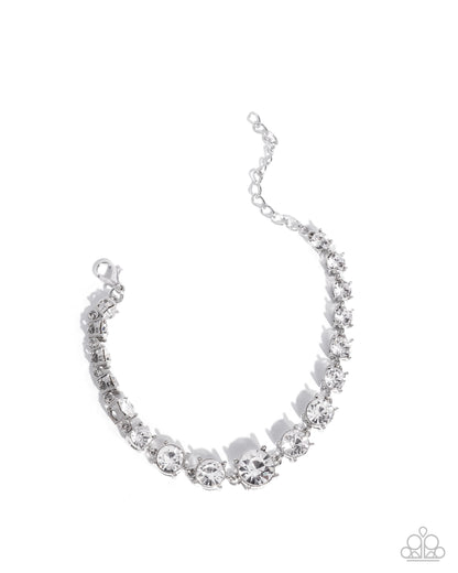 Silver bracelet with clear stones on a white background