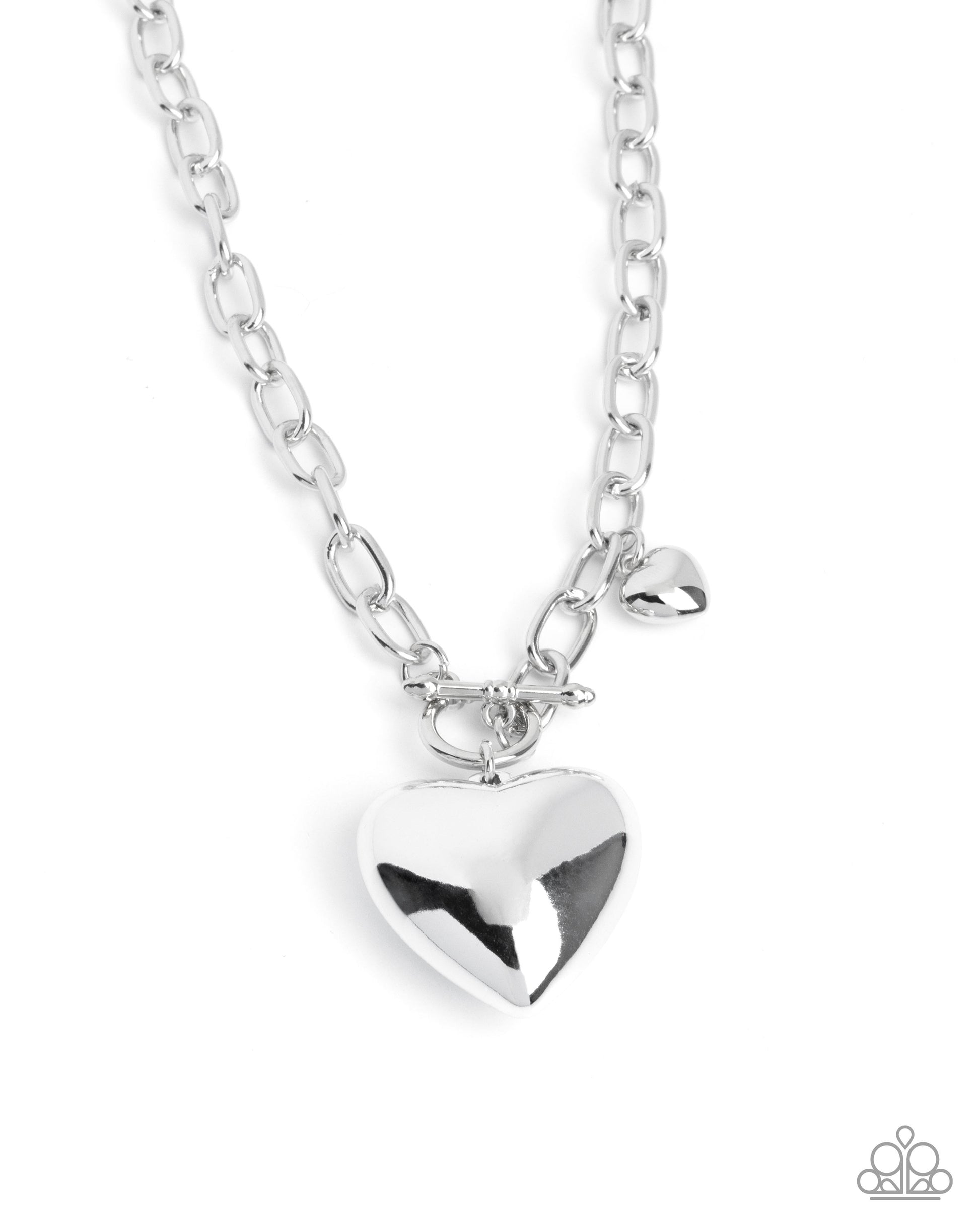 Silver heart-shaped pendant on a chain against a white background