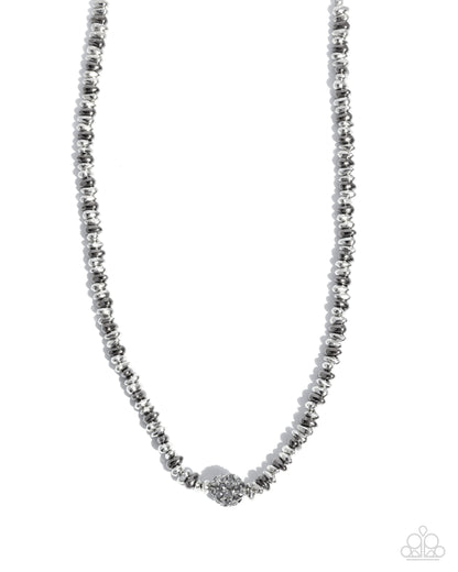 Silver beaded necklace on a white background