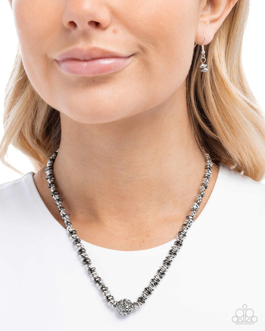 Necklace worn by a model on a white background