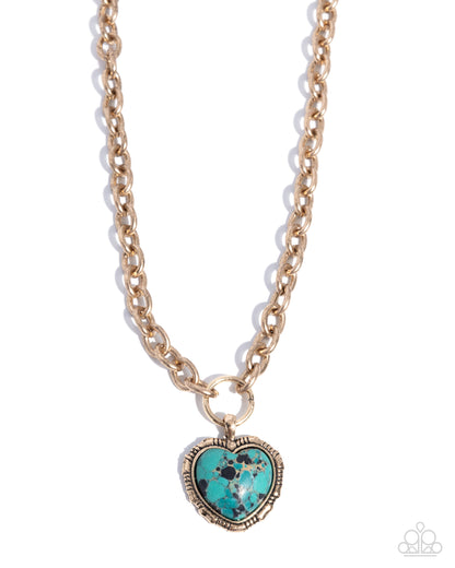 Gold necklace with a turquoise heart-shaped pendant on a white background