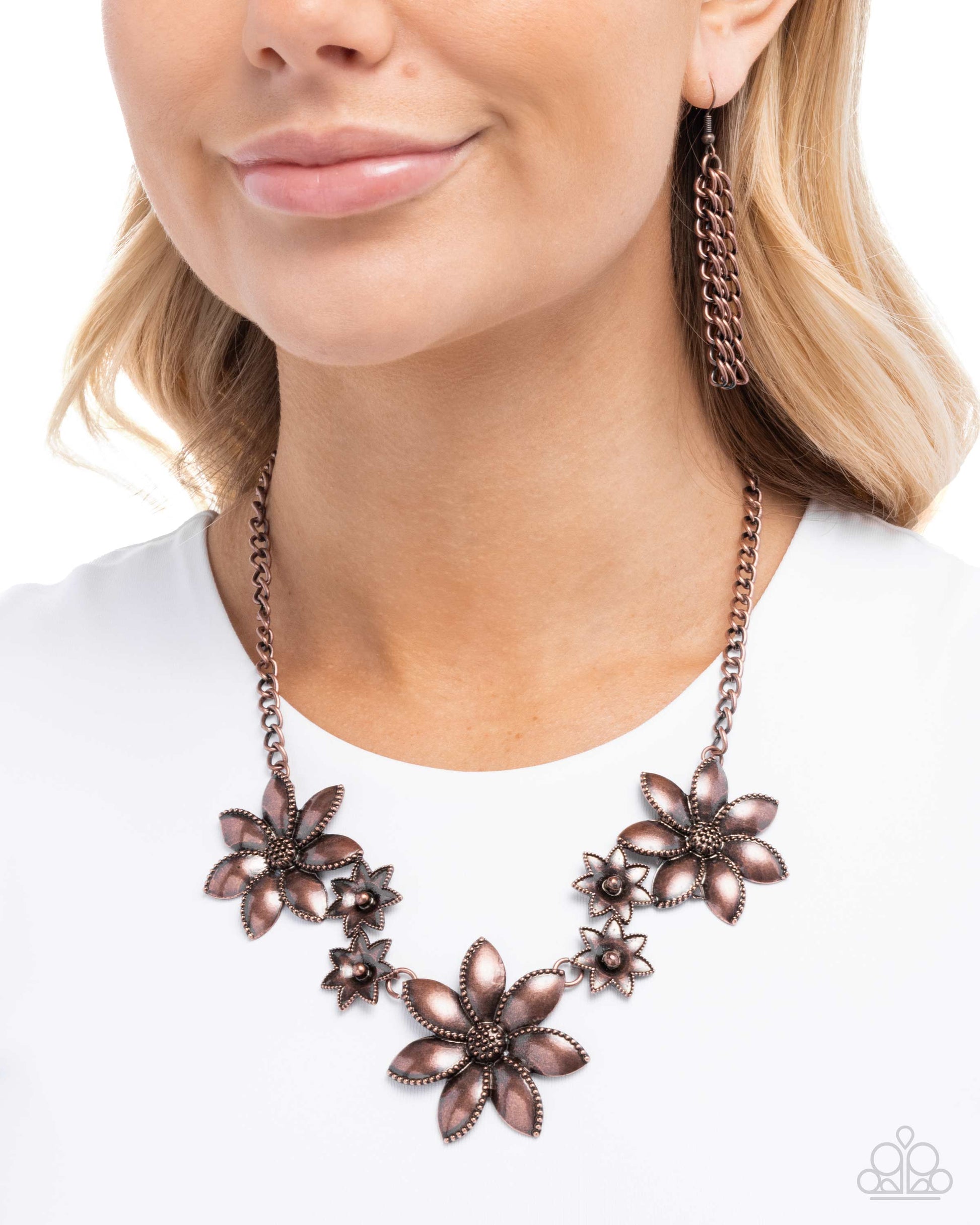 Woman wearing a bronze floral necklace on a white background
