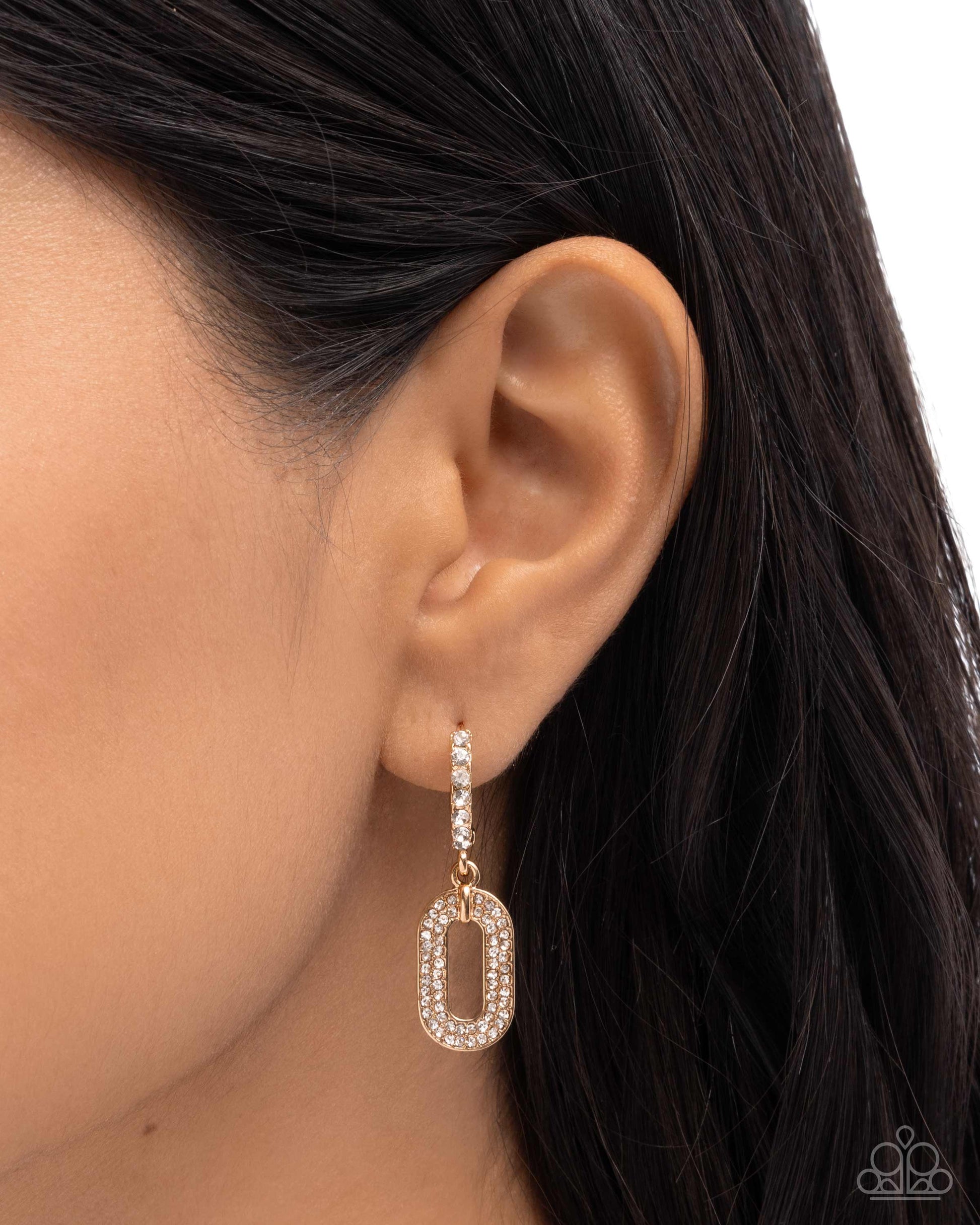 Earring worn on an ear with a plain background
