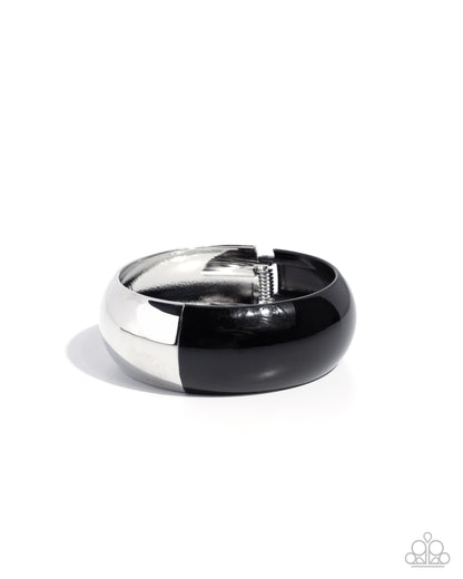 Black and silver ring on a white background