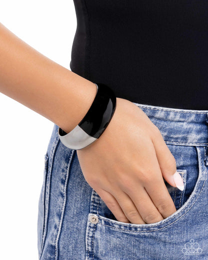 Person wearing a black smartwatch on a white background