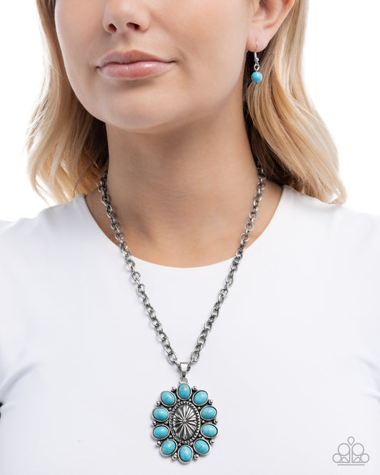 Woman wearing a turquoise necklace and earrings on a white background