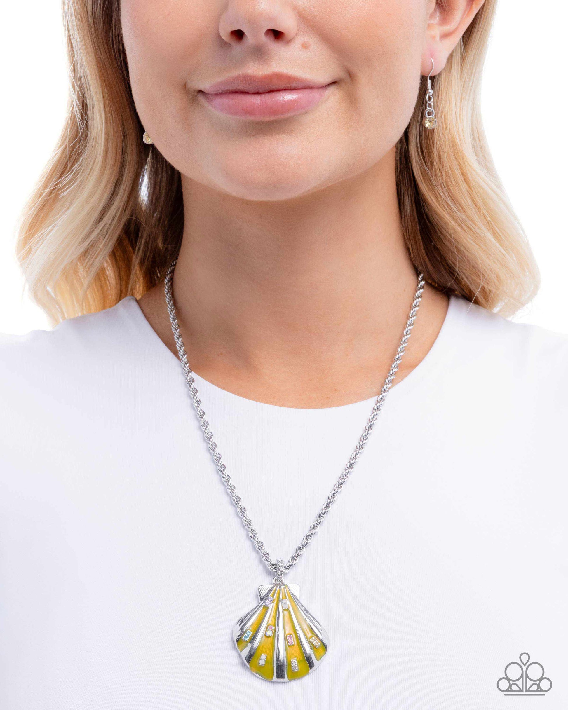 Woman wearing a yellow and silver pendant necklace on a white background