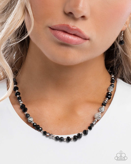 Necklace with black and silver beads worn by a model