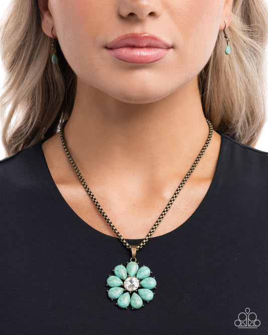 Turquoise flower necklace worn by a model on a black background