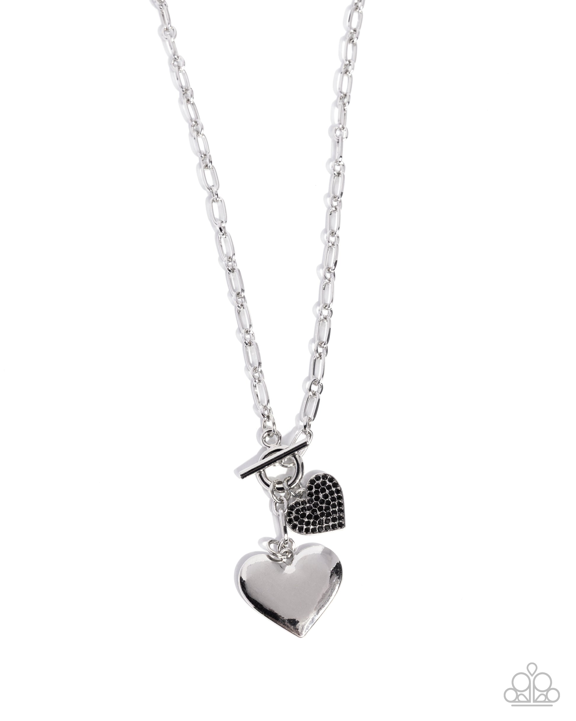 Silver necklace with heart and black heart pendant on a white background
