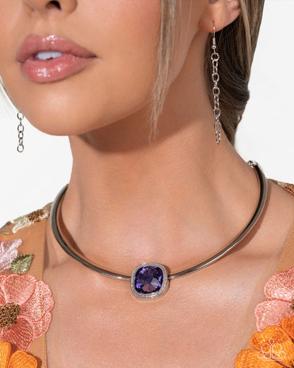 Close-up of a woman wearing a silver necklace with a purple gemstone and matching earrings.