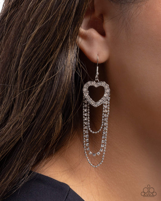 Earring with heart design worn by a person