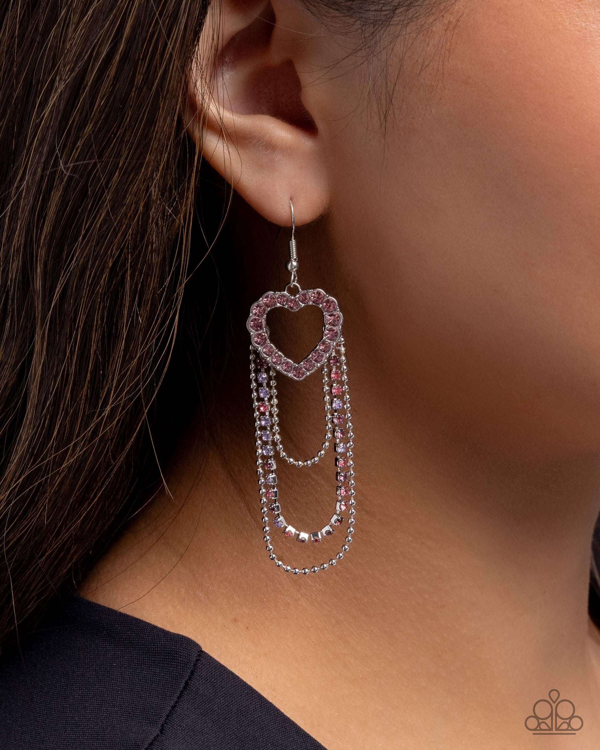 Close-up of an earring with layered design on a blurred background