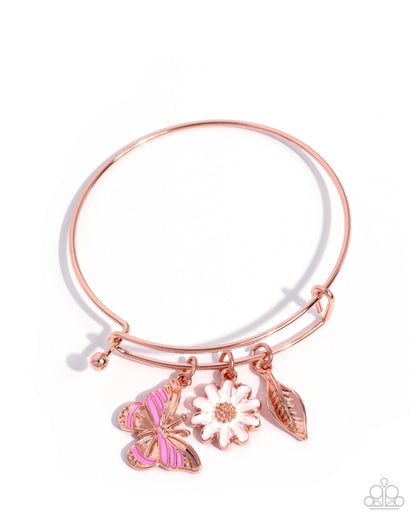 Rose gold bracelet with butterfly, flower, and leaf charms on a white background