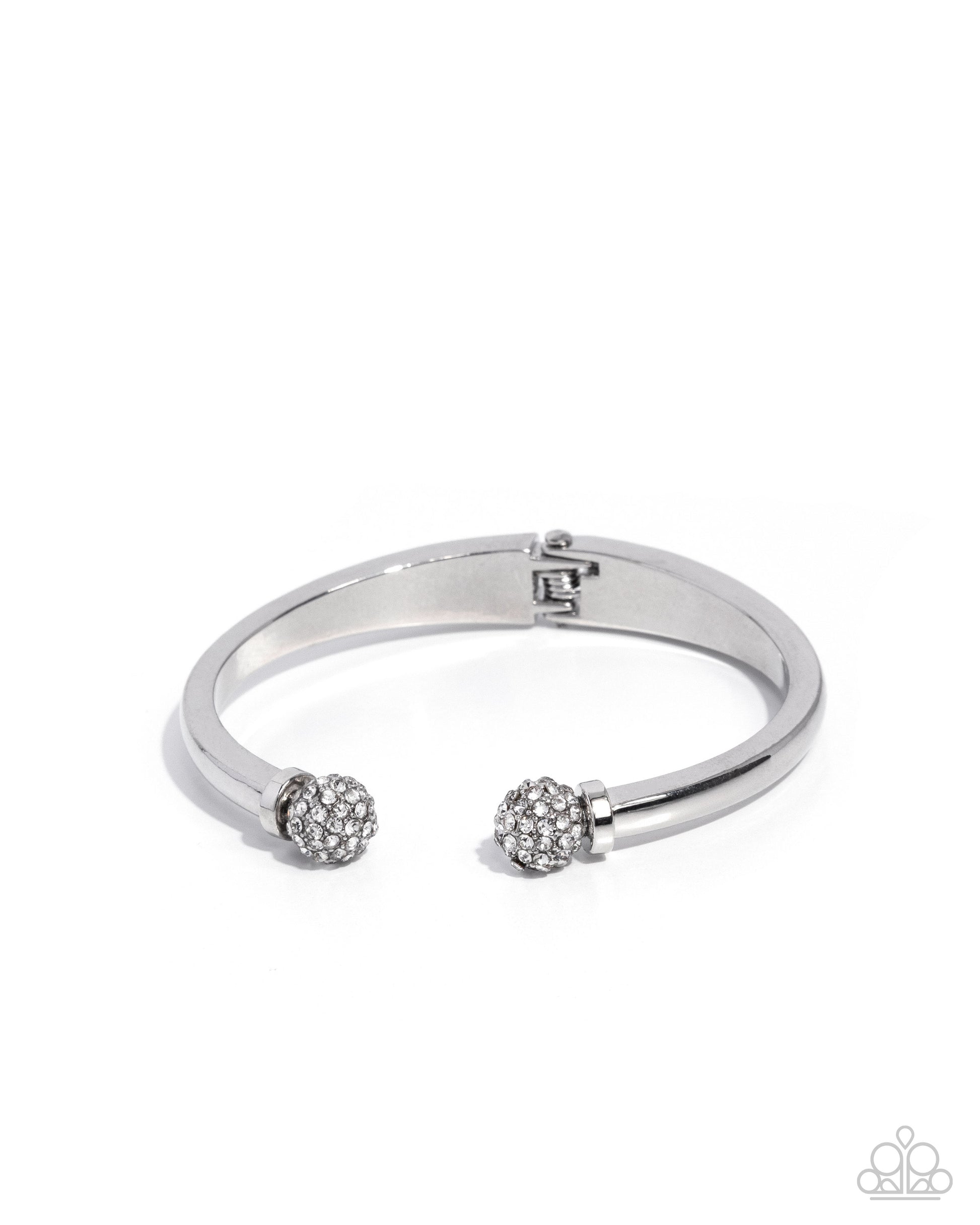 Silver bracelet with two spherical charms on a white background
