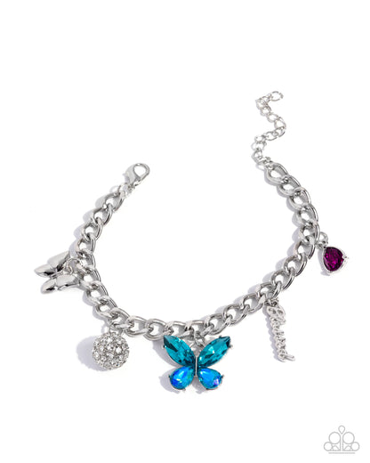 Silver bracelet with various charms including a blue butterfly, purple teardrop, and silver ball on a white background
