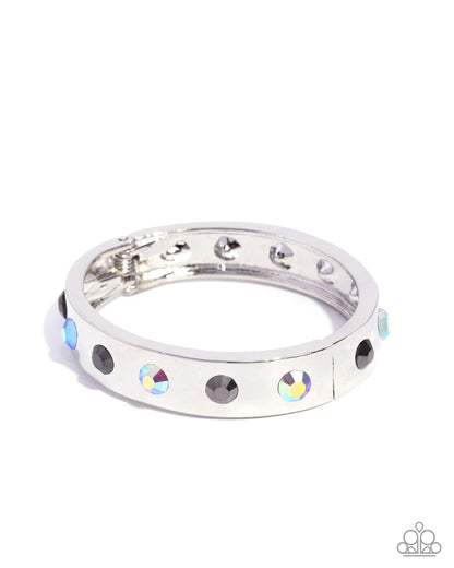 Silver ring with colorful gemstones on a white background