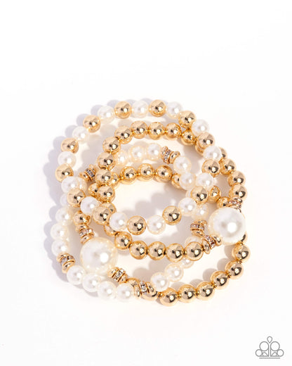 Gold and white beaded necklace on a white background