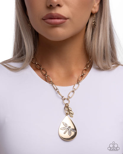 Necklace with a gold pendant worn by a person on a white background