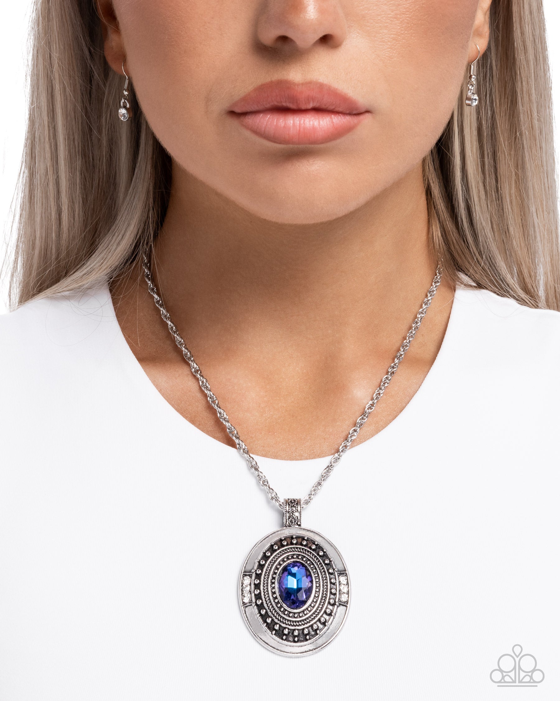 Necklace with a blue pendant worn by a person on a white background