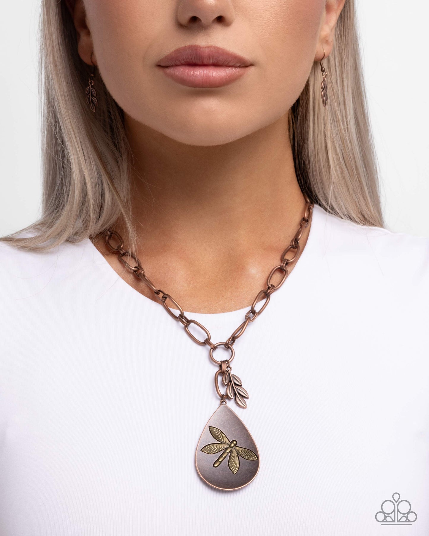 Necklace with a teardrop-shaped pendant featuring a dragonfly design on a white background