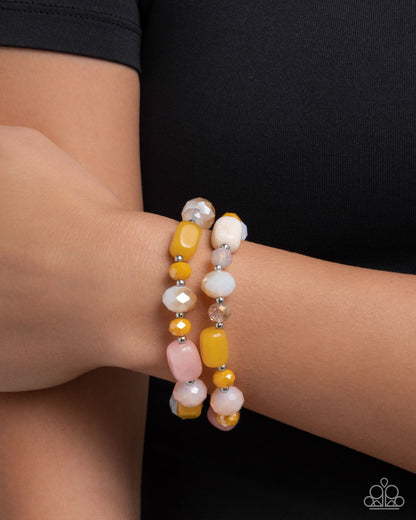 Beaded bracelet on a wrist with a black background