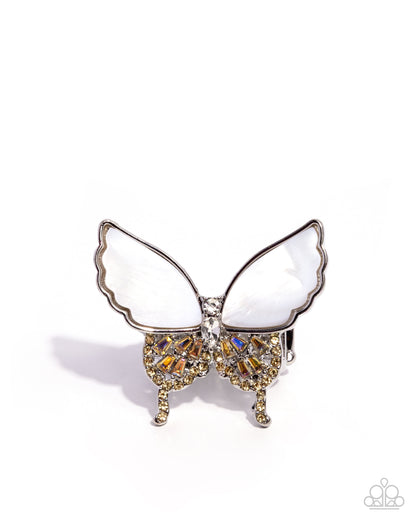 Butterfly-shaped brooch with white wings and gold and brown accents on a white background