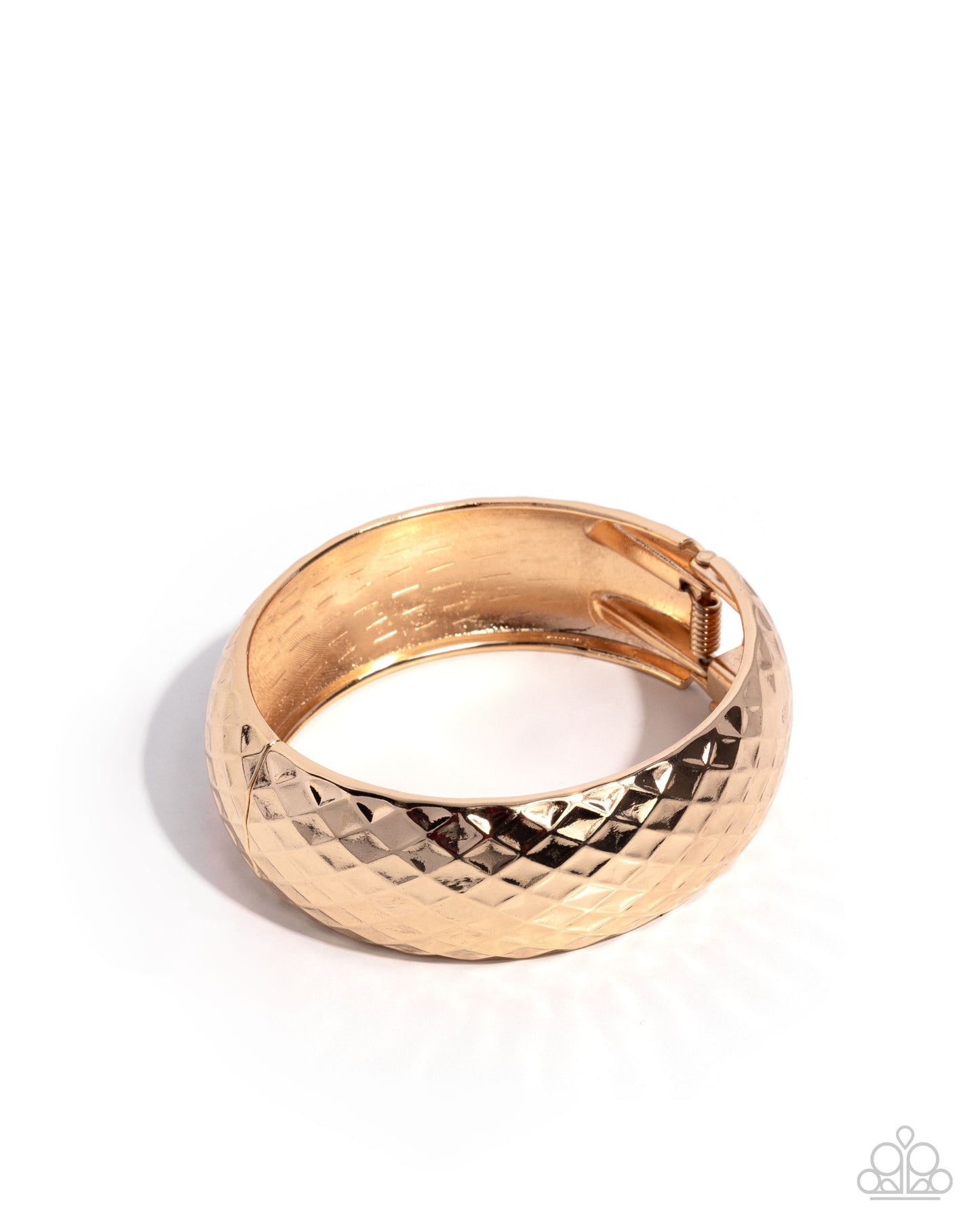 Gold bangle with textured design on a white background