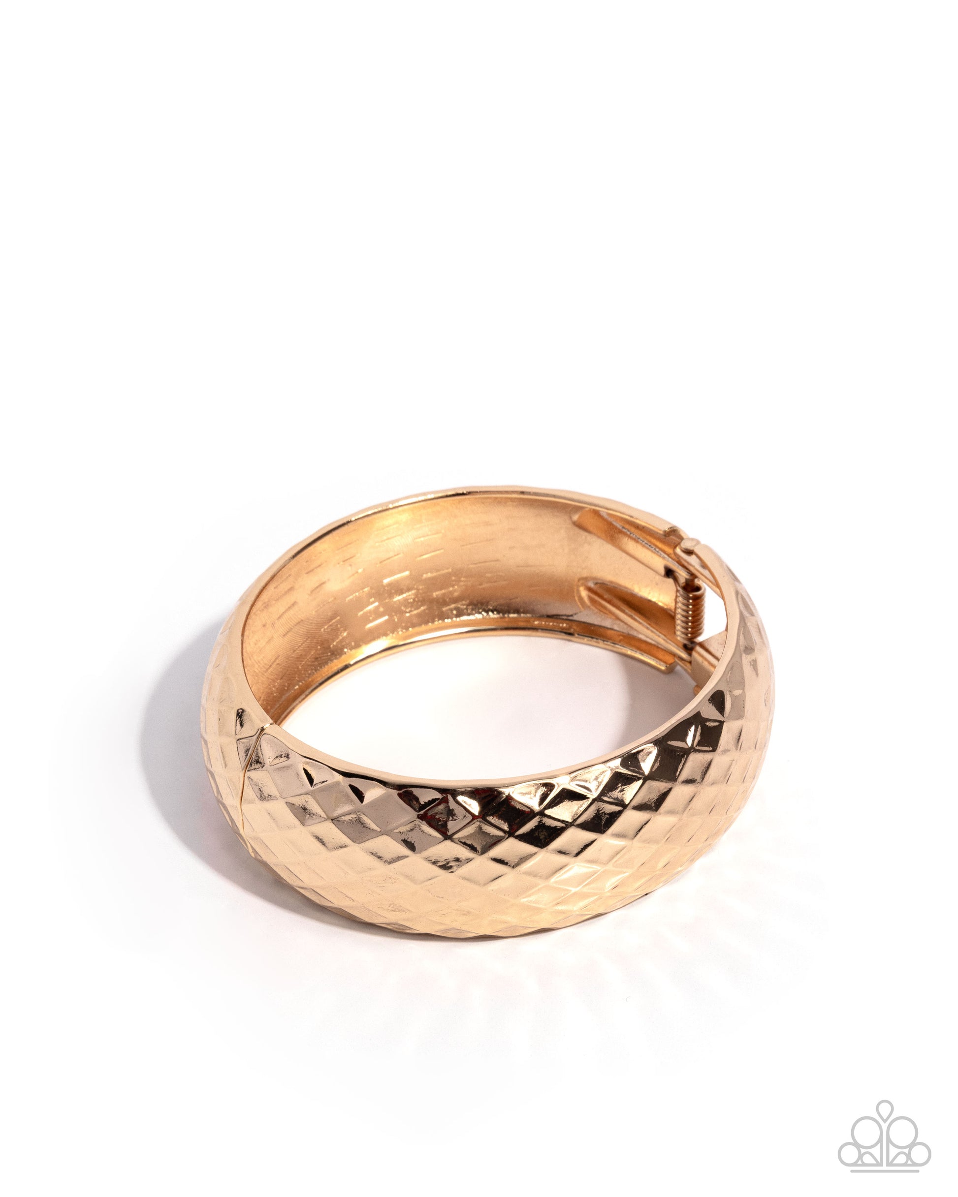 Gold bangle with textured design on a white background