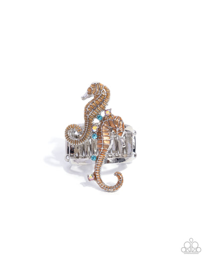 Silver ring with a seahorse design on a white background