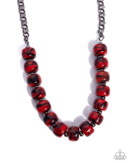 Necklace with red and black beaded strands on a white background