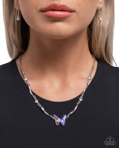 Necklace with a butterfly pendant worn by a model on a white background