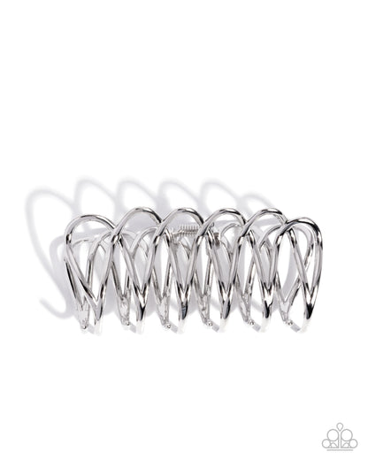 Silver hair crimping tool on a white background