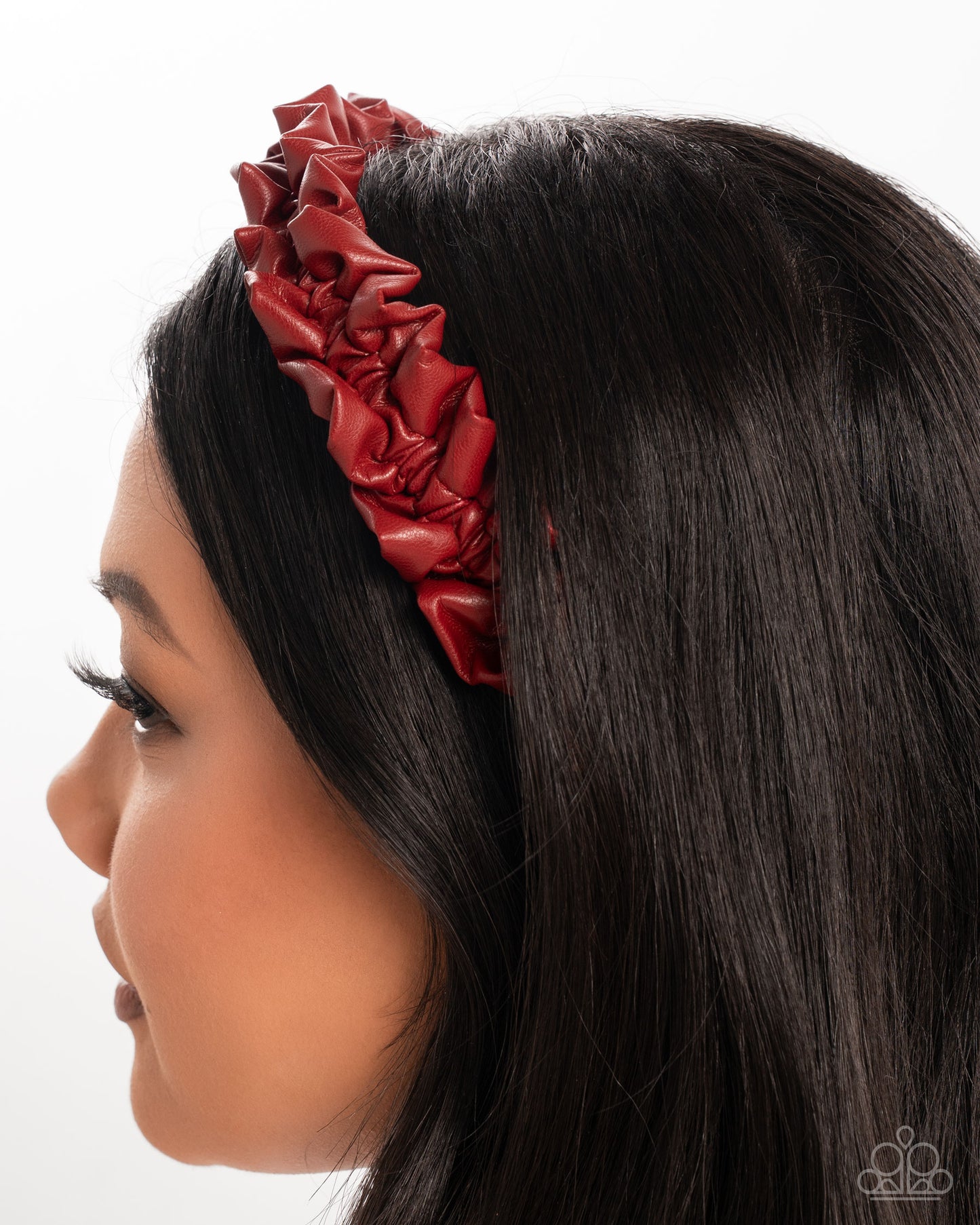 Red headband worn by a person with dark hair on a white background