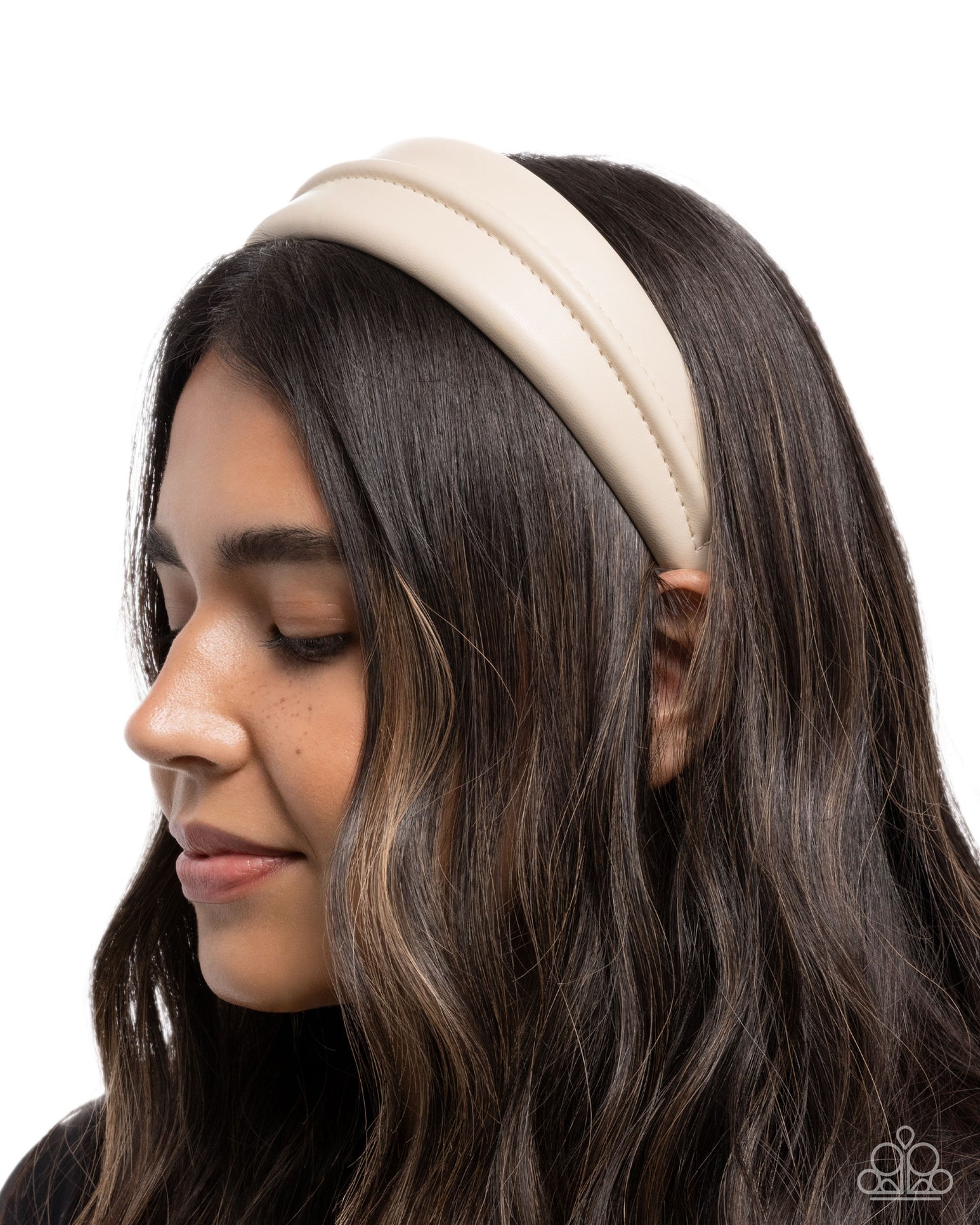 Woman wearing a beige headband on a white background