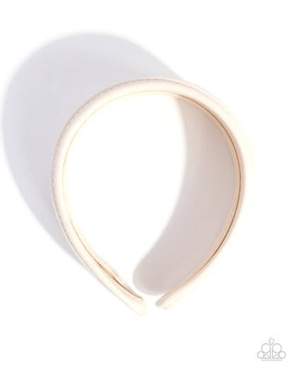 White headband with gold band on a white background