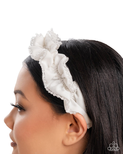 Woman wearing a white lace headband on a white background