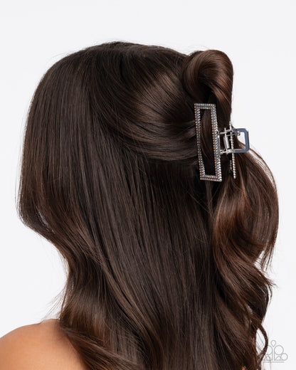 Hair clip in a person's hair with a white background