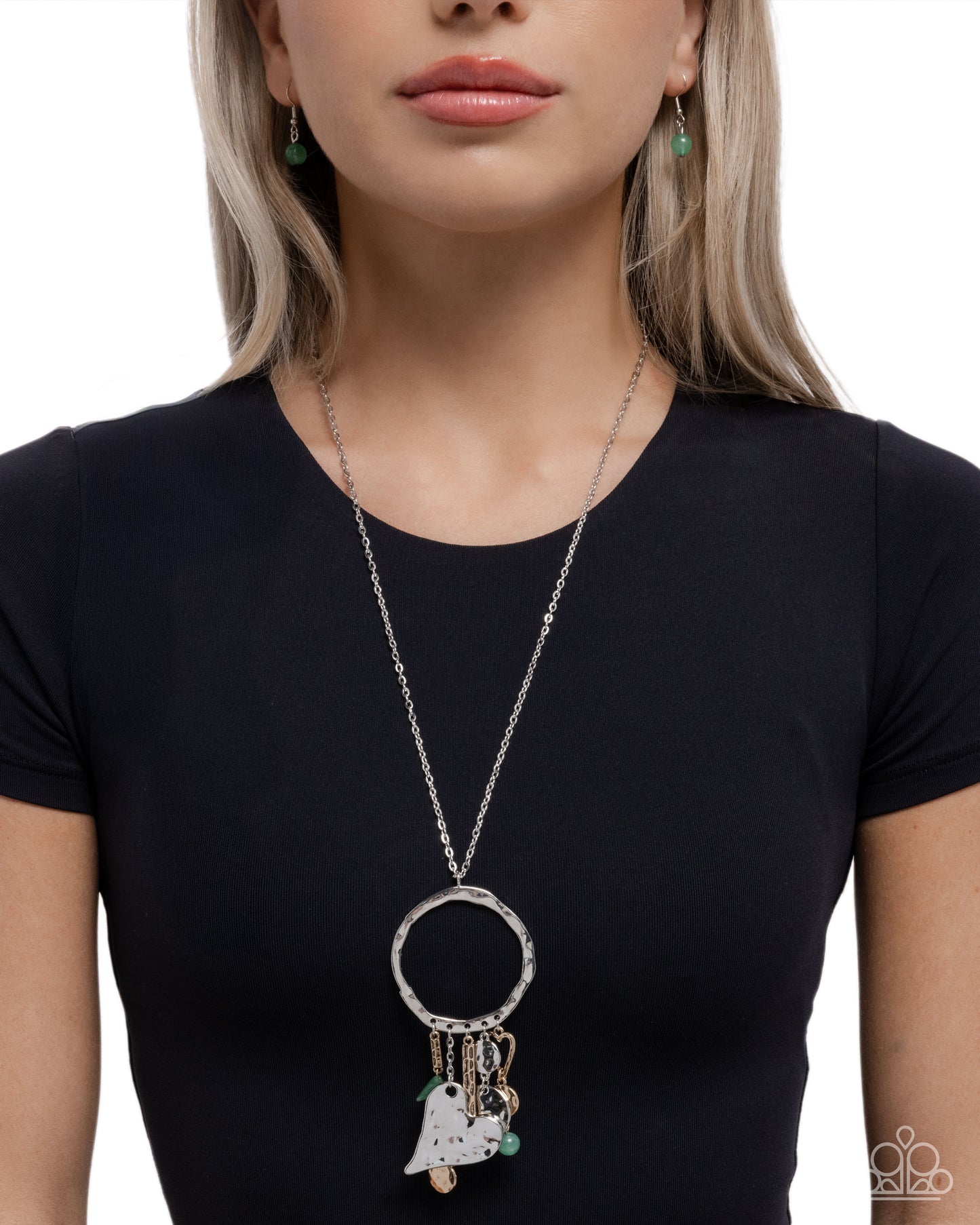 Woman wearing a long necklace with a pendant on a white background