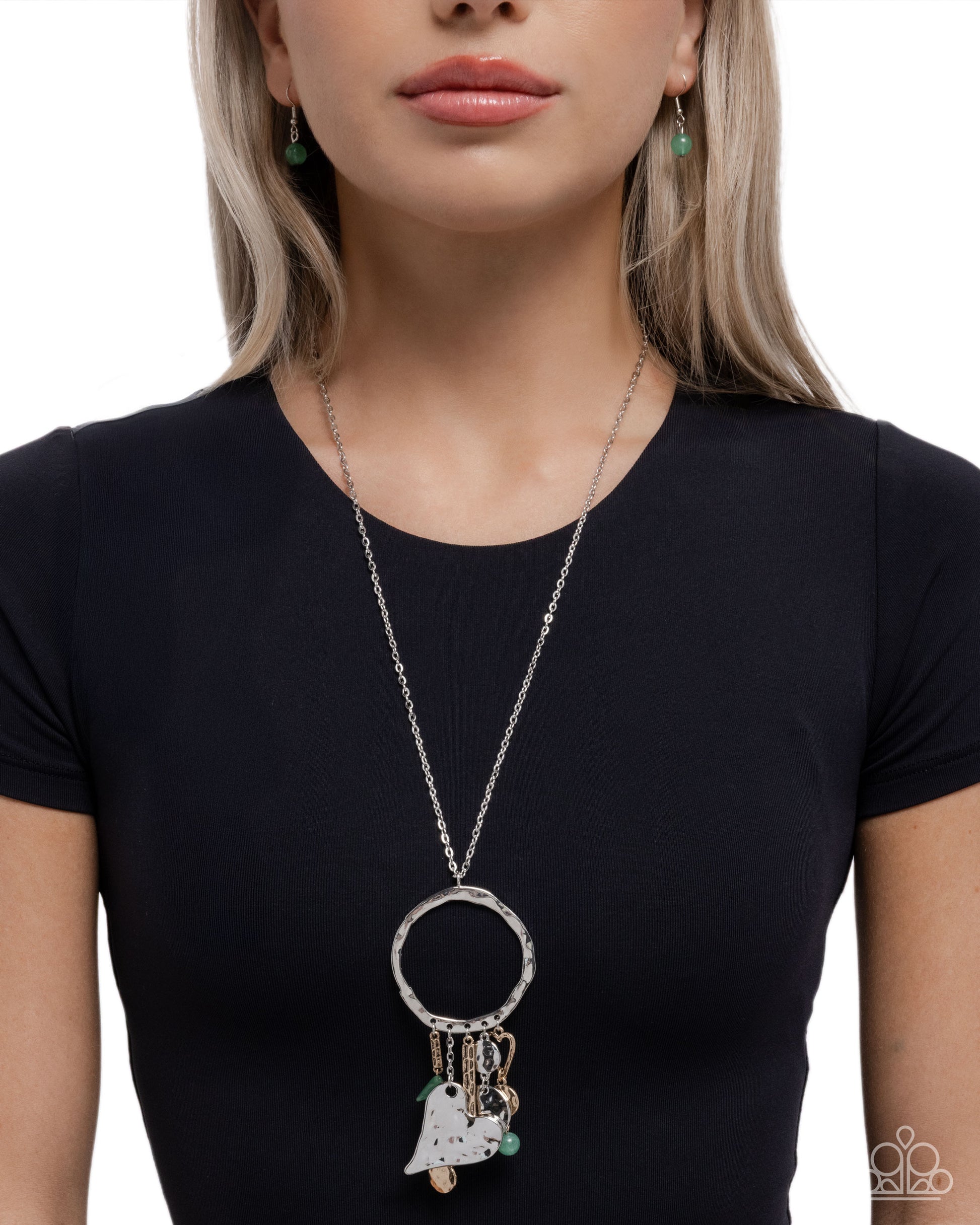 Woman wearing a long necklace with a pendant on a white background