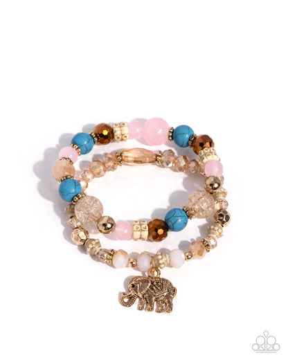 Multicolored beaded bracelet with gold elephant charm on a white background